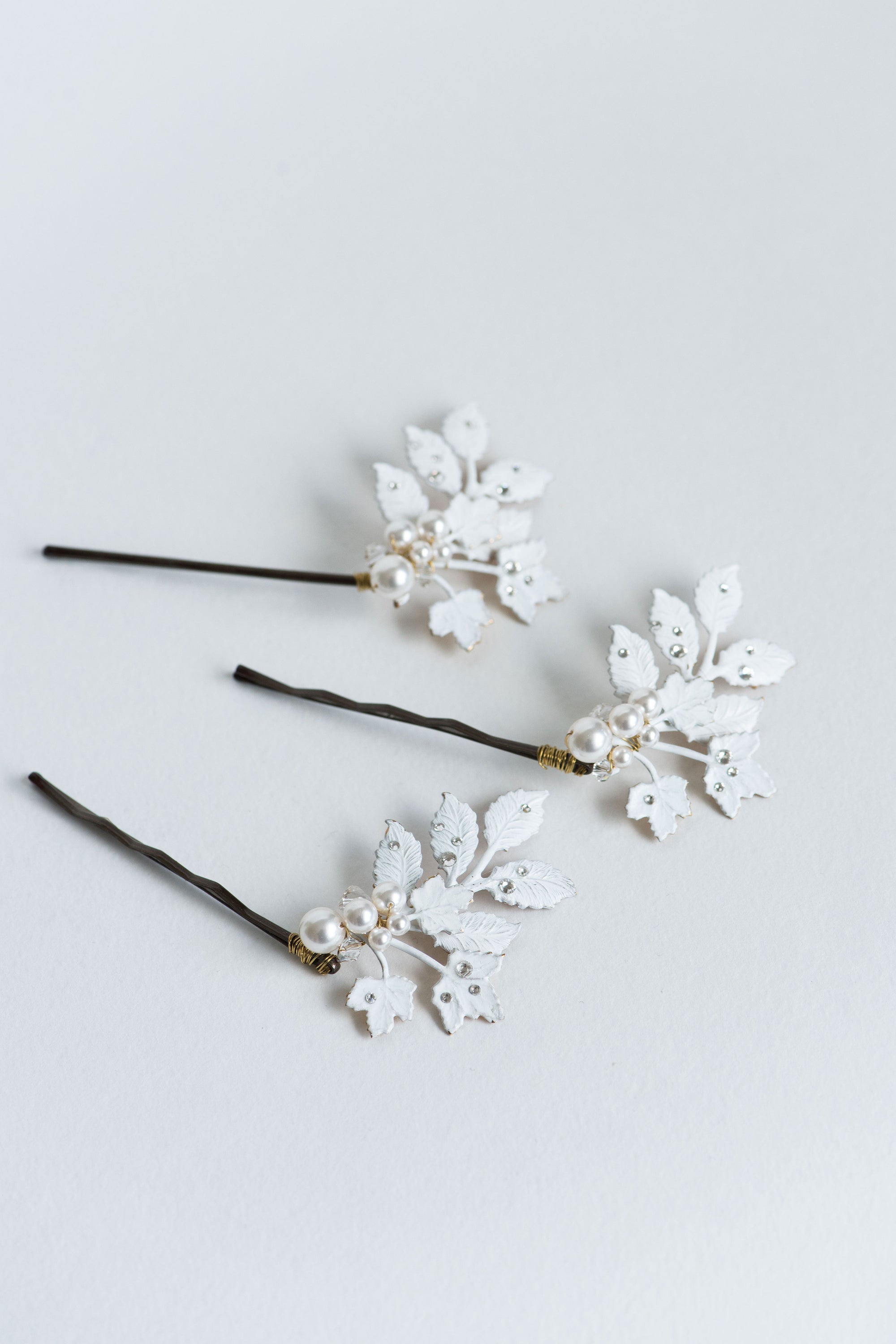 Set of three white frosted bridal hair pins with pearl accents