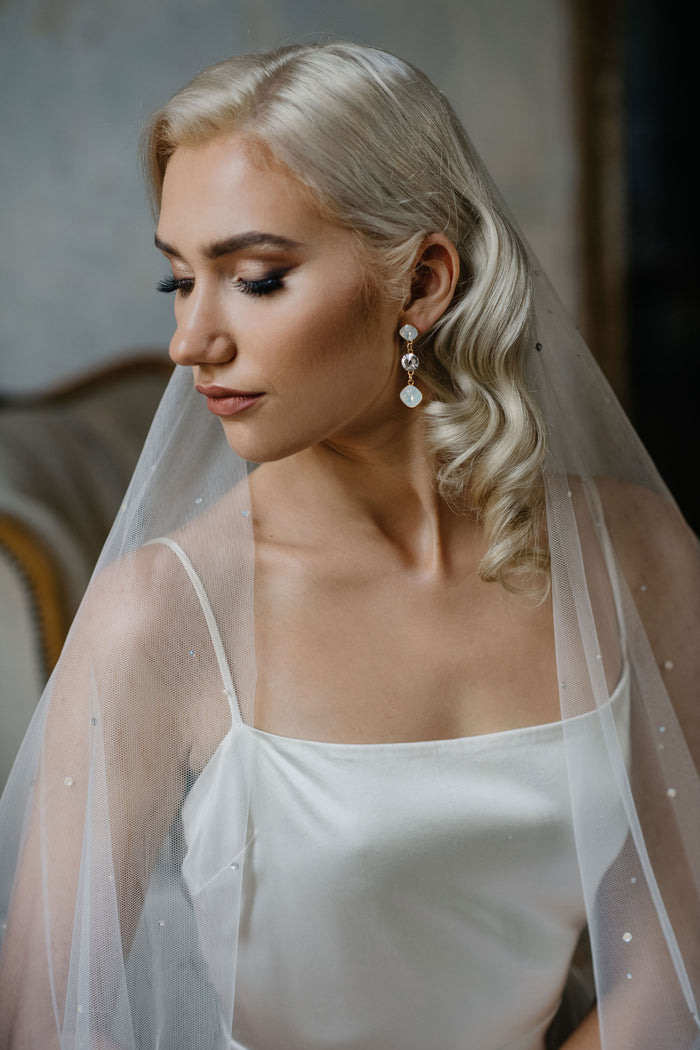 Bride with drop white opal earrings by floraljewellery