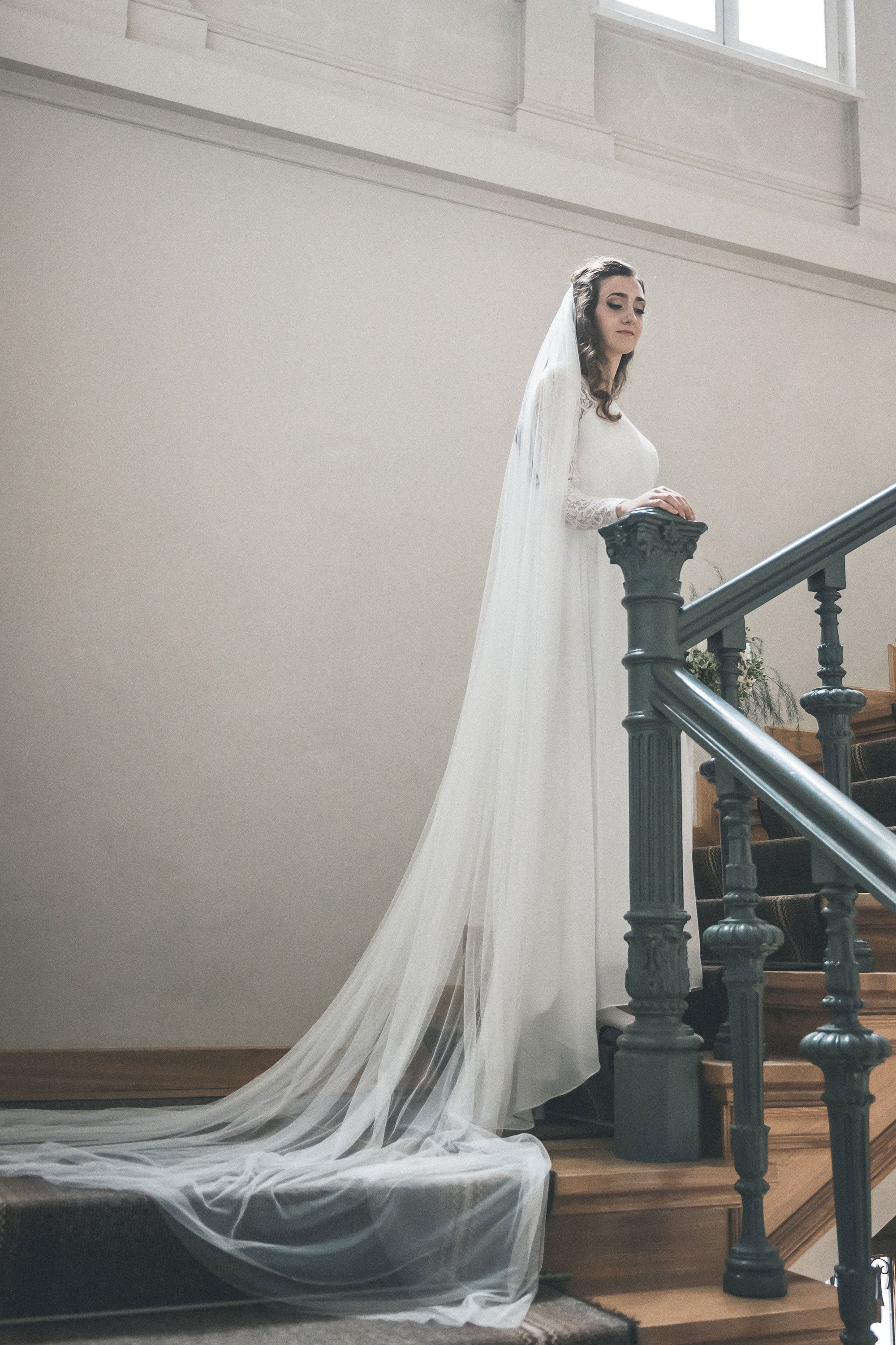 Bride wearing HARRIET wide cathedral veil made of soft English tulle, flowing in natural light
