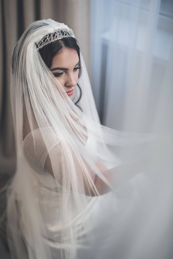 Bride wearing HARRIET wide cathedral veil made of soft English tulle, flowing in natural light with silver tiara