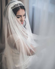 Bride wearing HARRIET wide cathedral veil made of soft English tulle, flowing in natural light with silver tiara