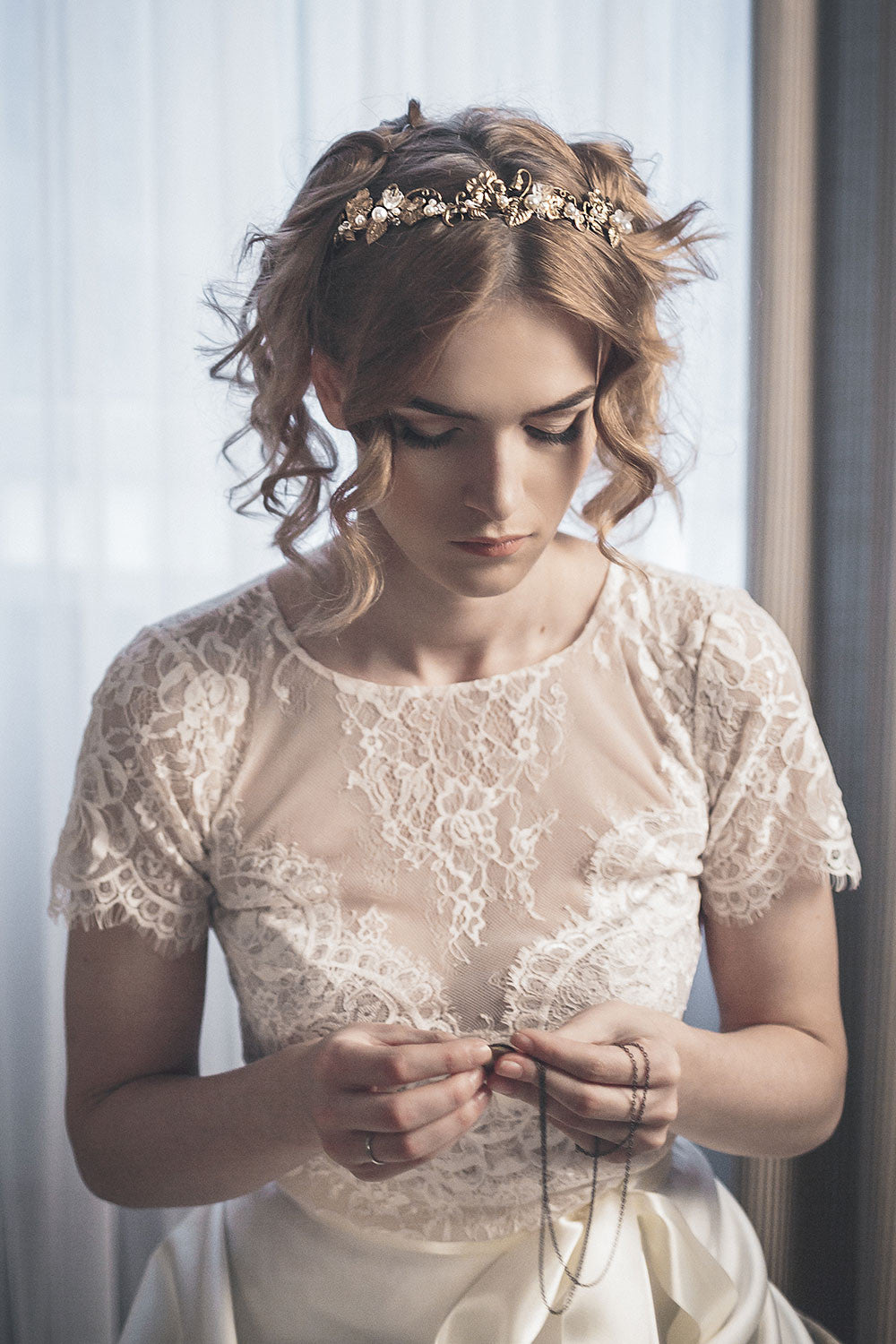Bride wearing SYBIL gold floral headband with pearls and crystals