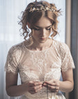 Bride wearing SYBIL gold floral headband with pearls and crystals