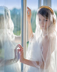 Modern bride wearing CLOTILDE golden laurel headband with wedding veil