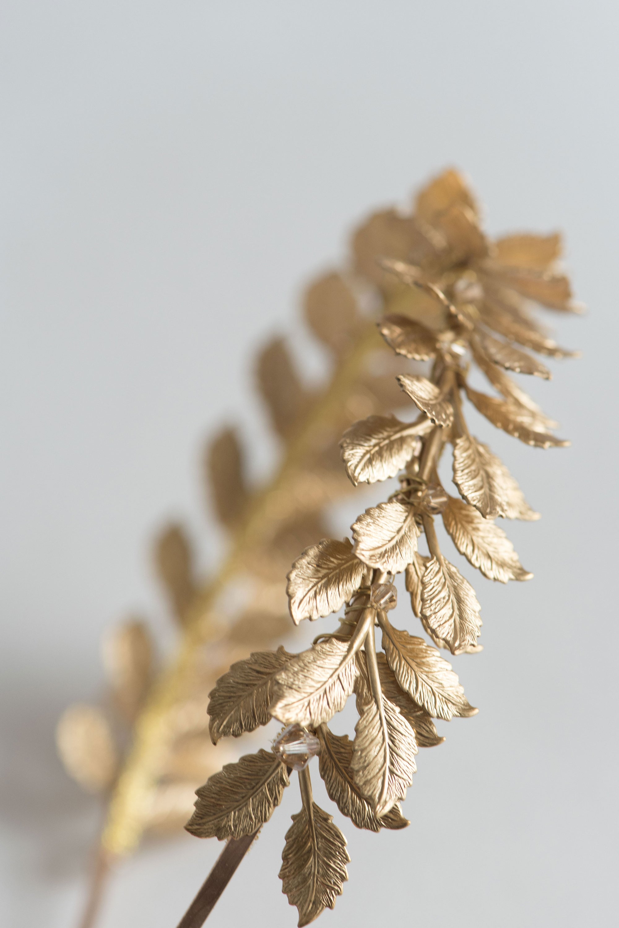 Close-up of golden leaves and crystals – CLOTILDE wedding headband detail