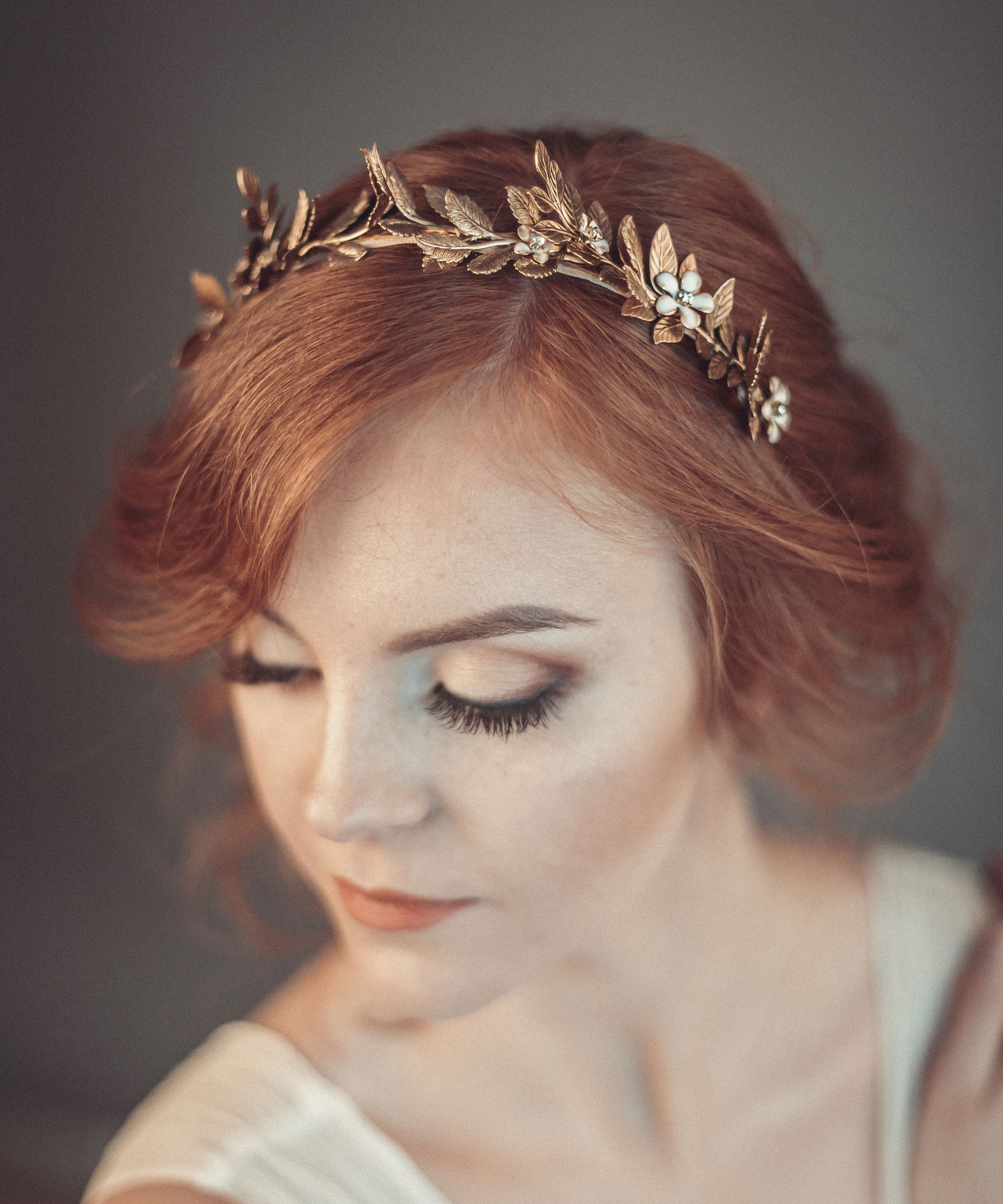 Bride wearing gold laurel leaf crown with matte brass leaves