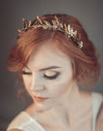 Bride wearing gold laurel leaf crown with matte brass leaves