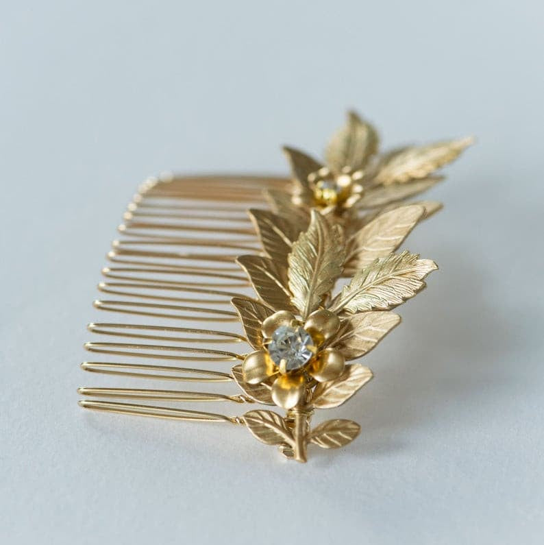 Botanical gold hair comb with leaf and  gold flower design with rhinestones in center