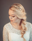Close-up of CARPO bridal headband showing curated brass oak leaves and hand-wired pearls for a minimalist botanical look.