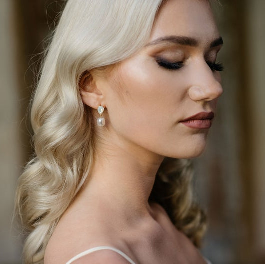 Bride wearing baroque pearl drop earrings with crystal accent, bridal jewelry close up, elegant wedding earrings