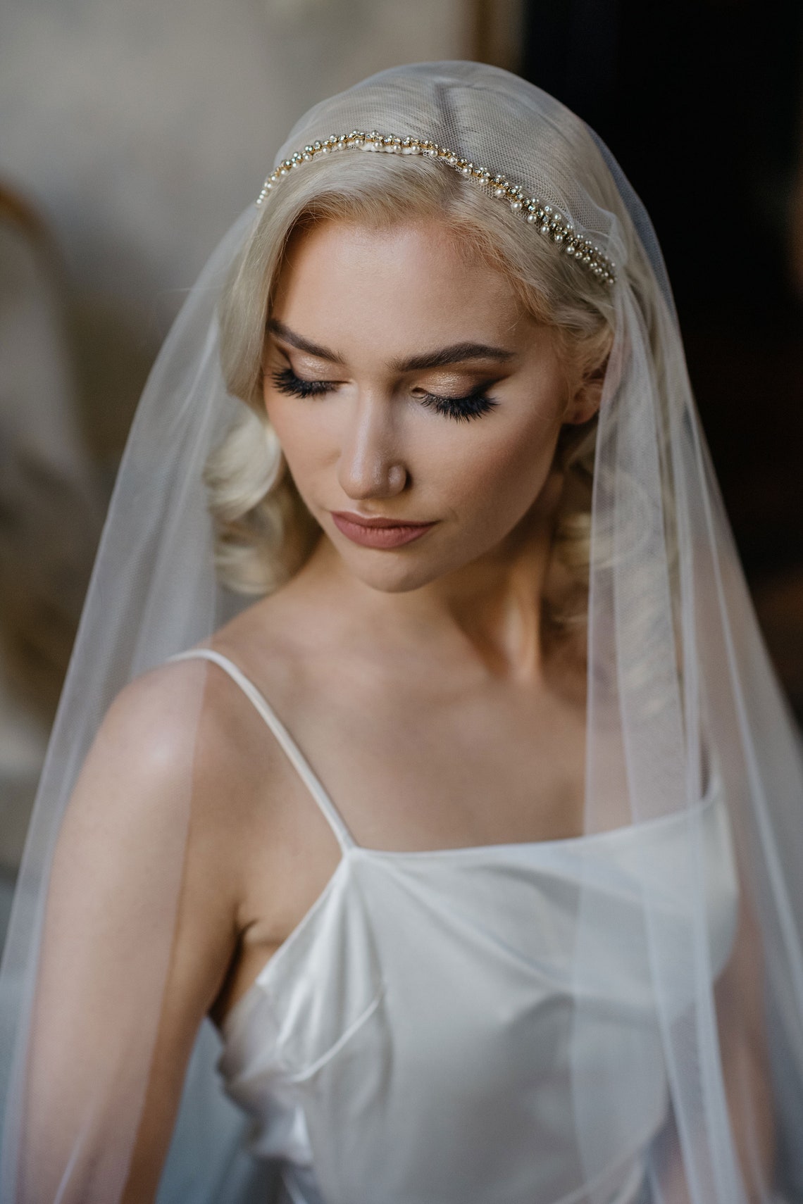 Bride wearing the Marlena Juliet cap veil with delicate pearls and crystals row
