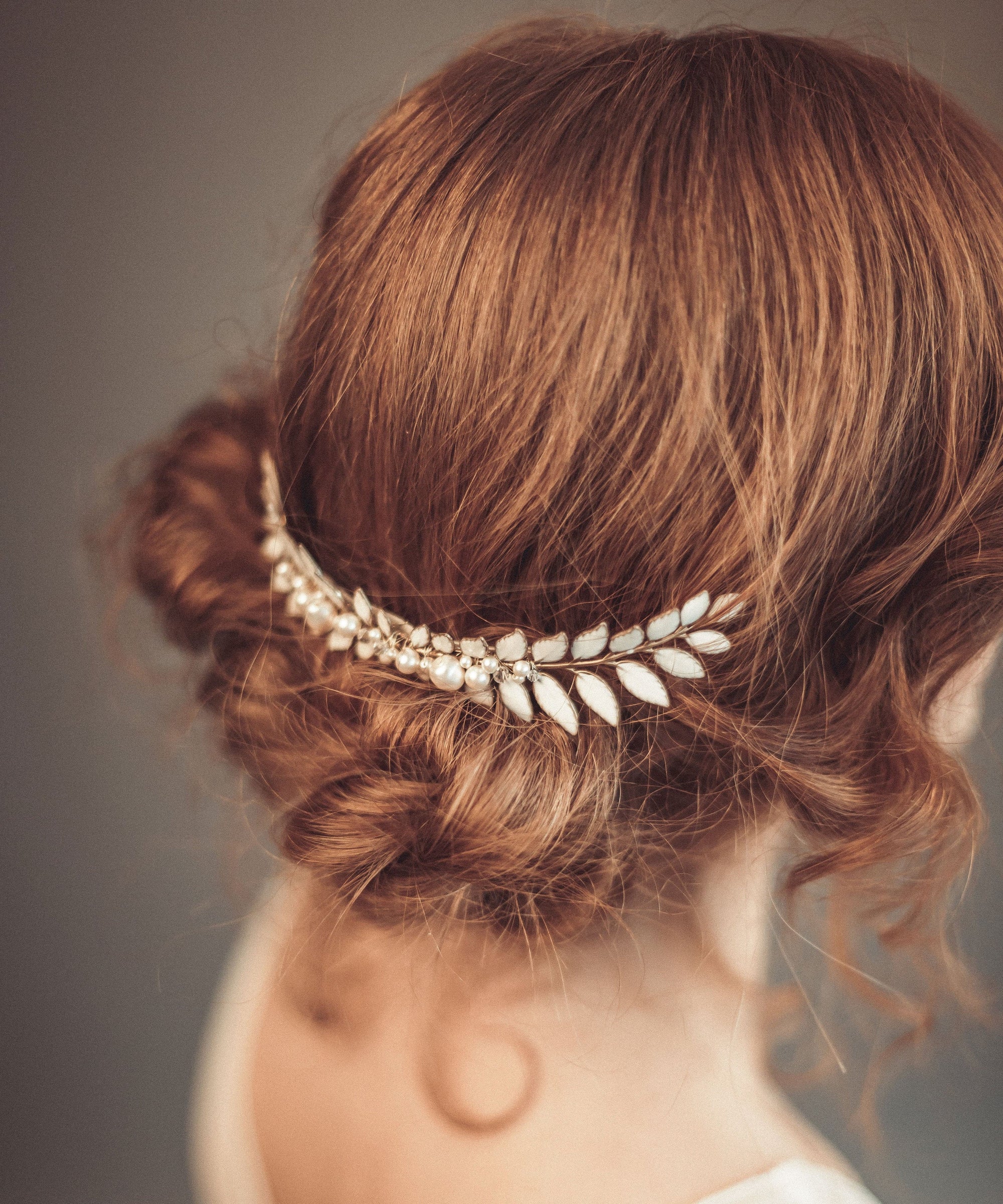 Close-up of ERATO bridal laurel hair comb showing enameled leaf and pearl details
