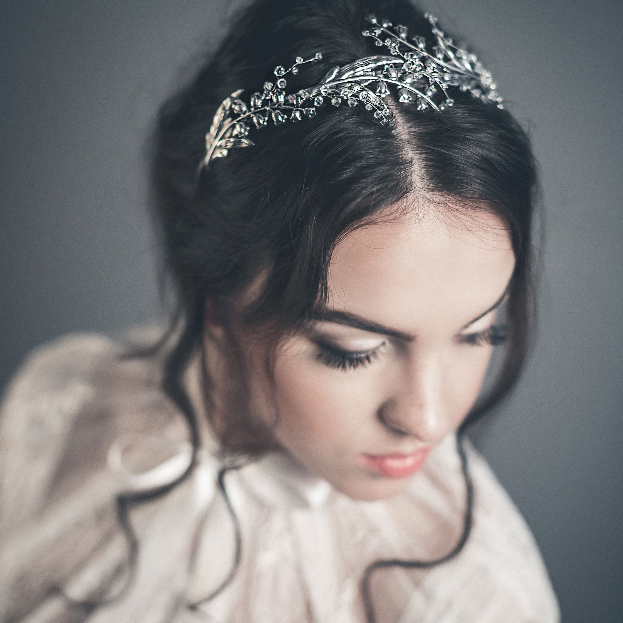 Bride wearing the LILY silver lily of the valley bridal tiara with Austrian crystals, romantic wedding headpiece.