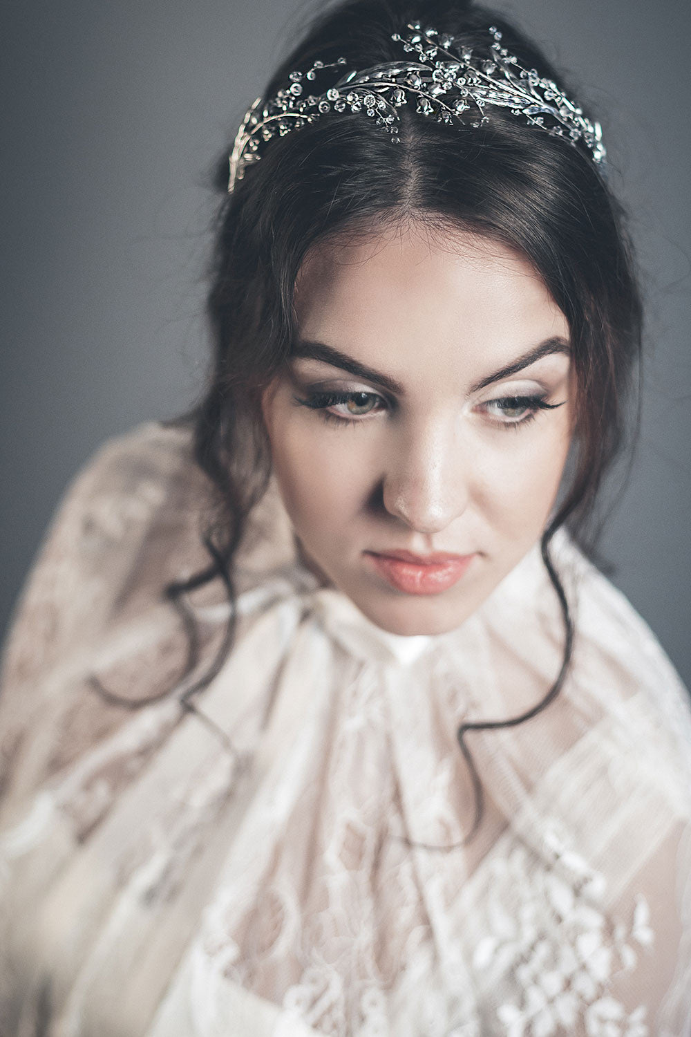 Close-up view of the silver lily of the valley crown on a bride, showing the delicate floral details and clear crystals.