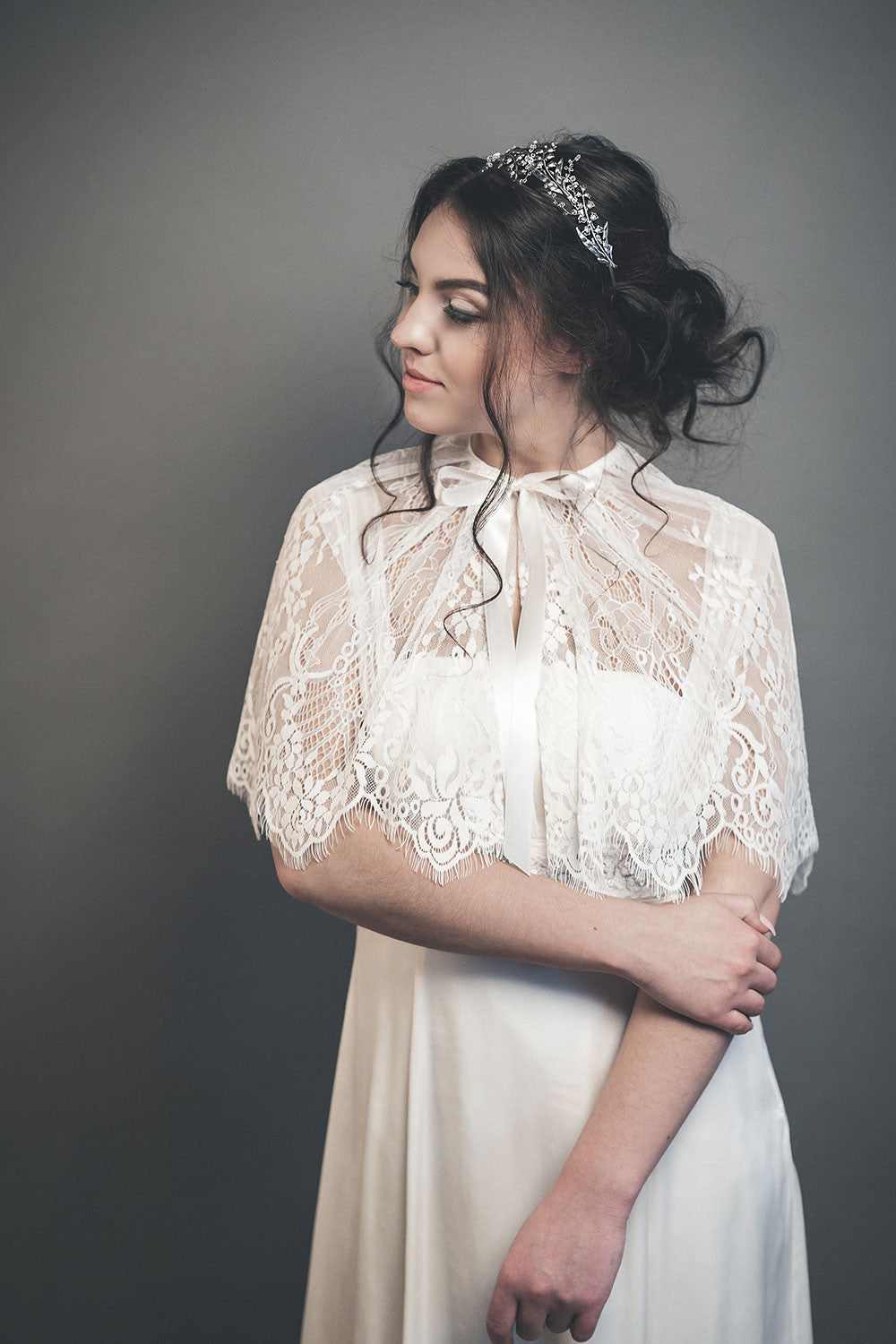 Side view of the LILY floral headpiece, showcasing how the silver twigs and lily of the valley buds wrap around the hairstyle.
