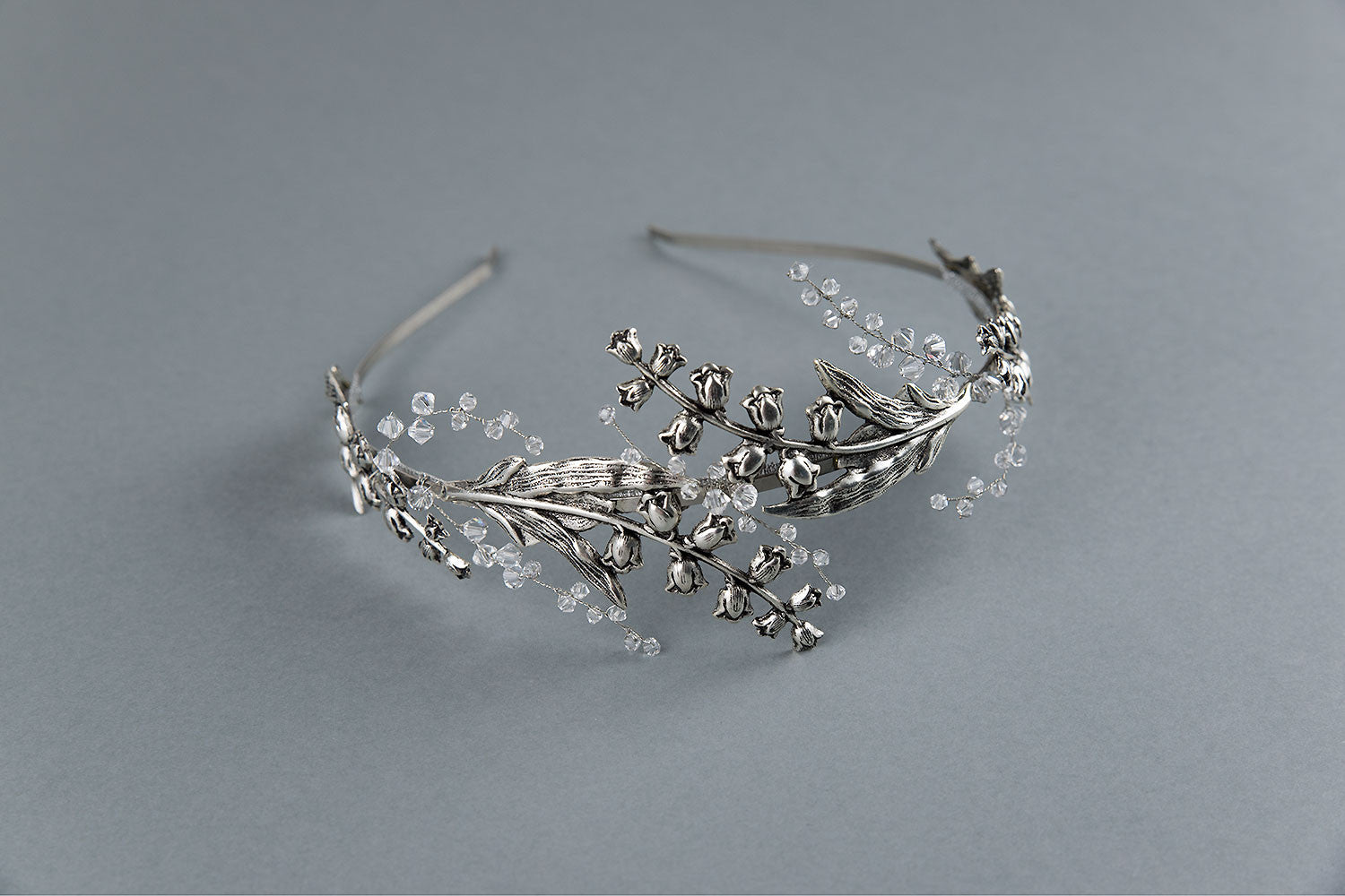 Top view of the LILY bridal tiara, displaying the intricate arrangement of silver flowers and jewelry wire work.