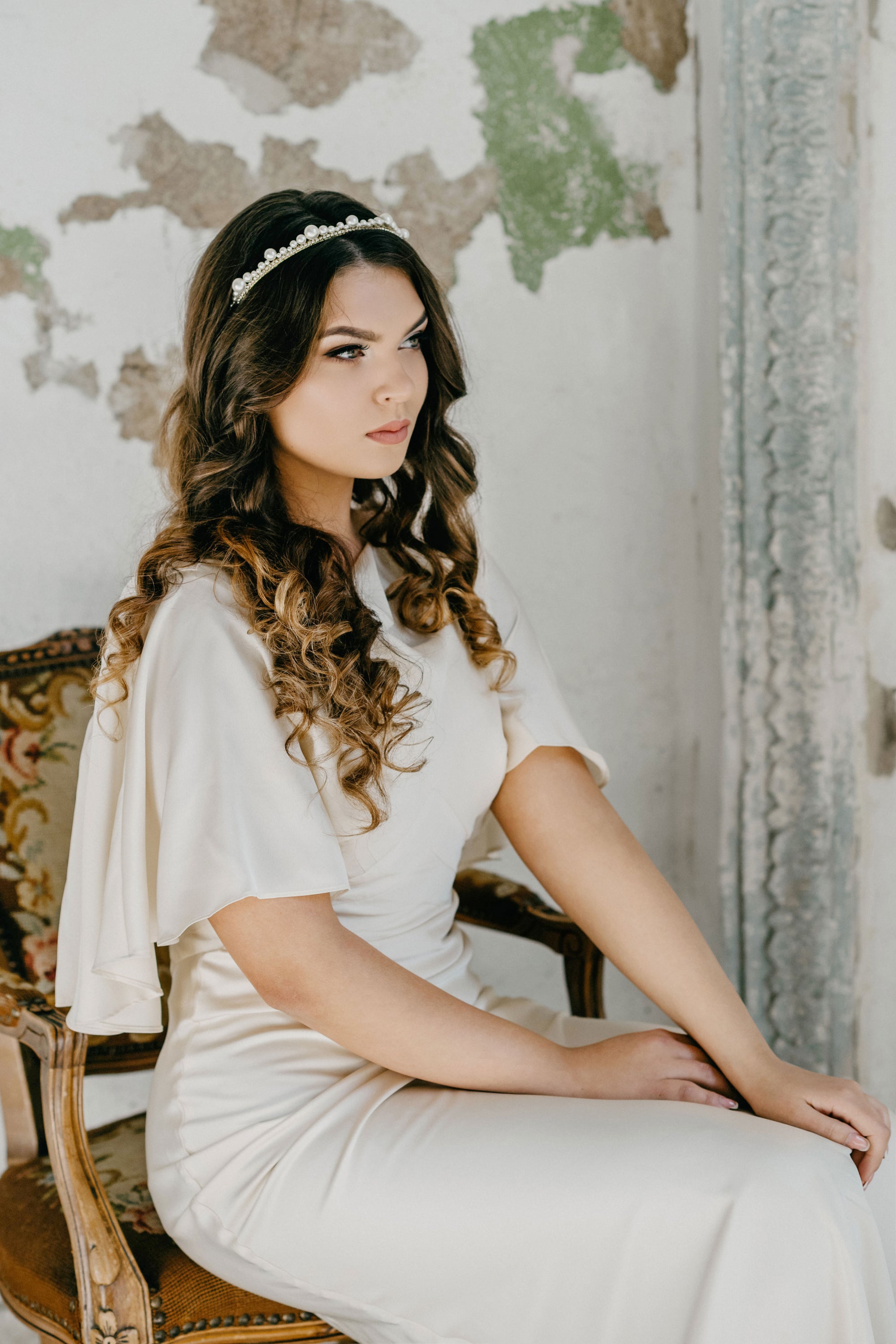 Model wearing ERDME pearl and crystal tiara in ivory cream with gold headband