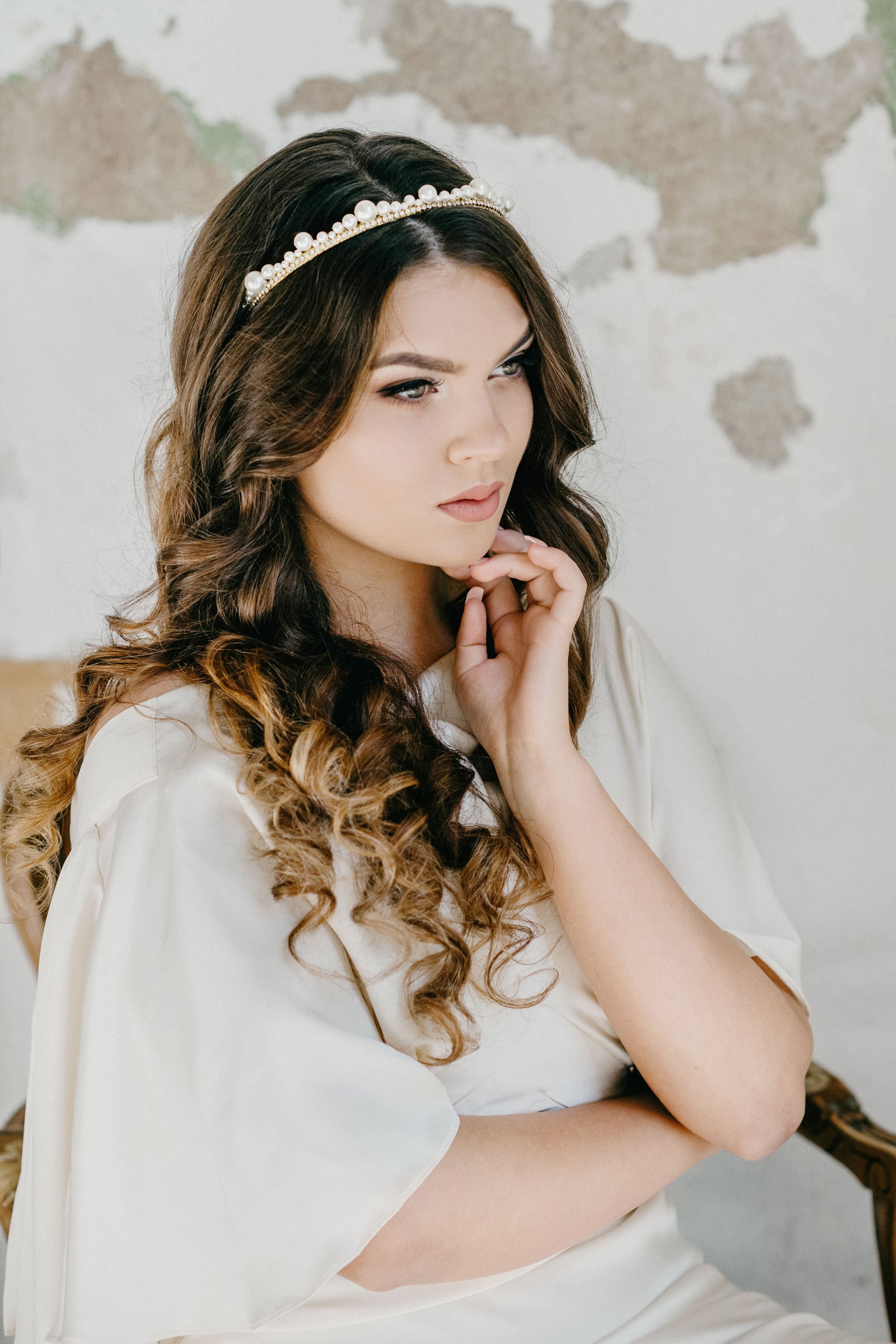 Model wearing ERDME pearl and crystal tiara in ivory cream with gold headband