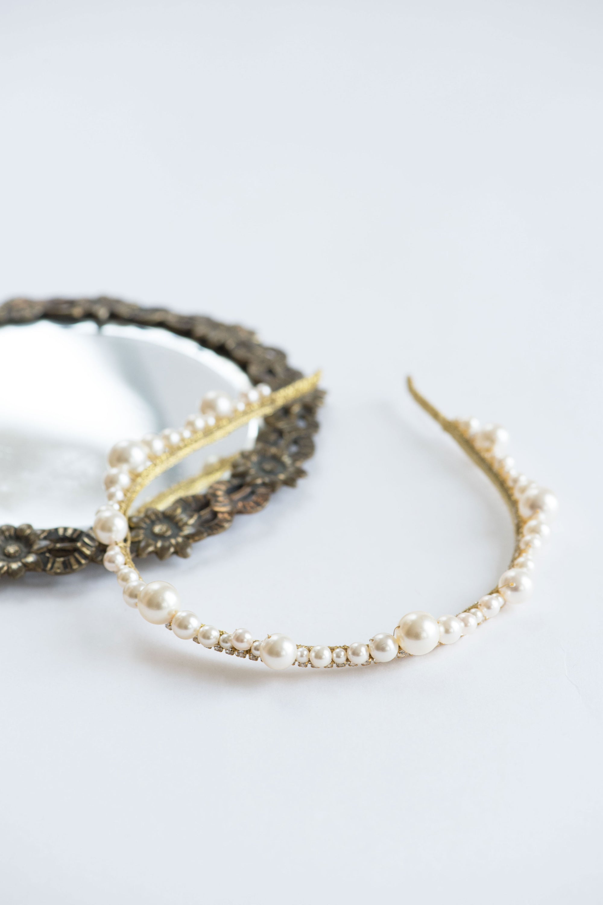 Close-up of delicate pearl and crystal bridal tiara details