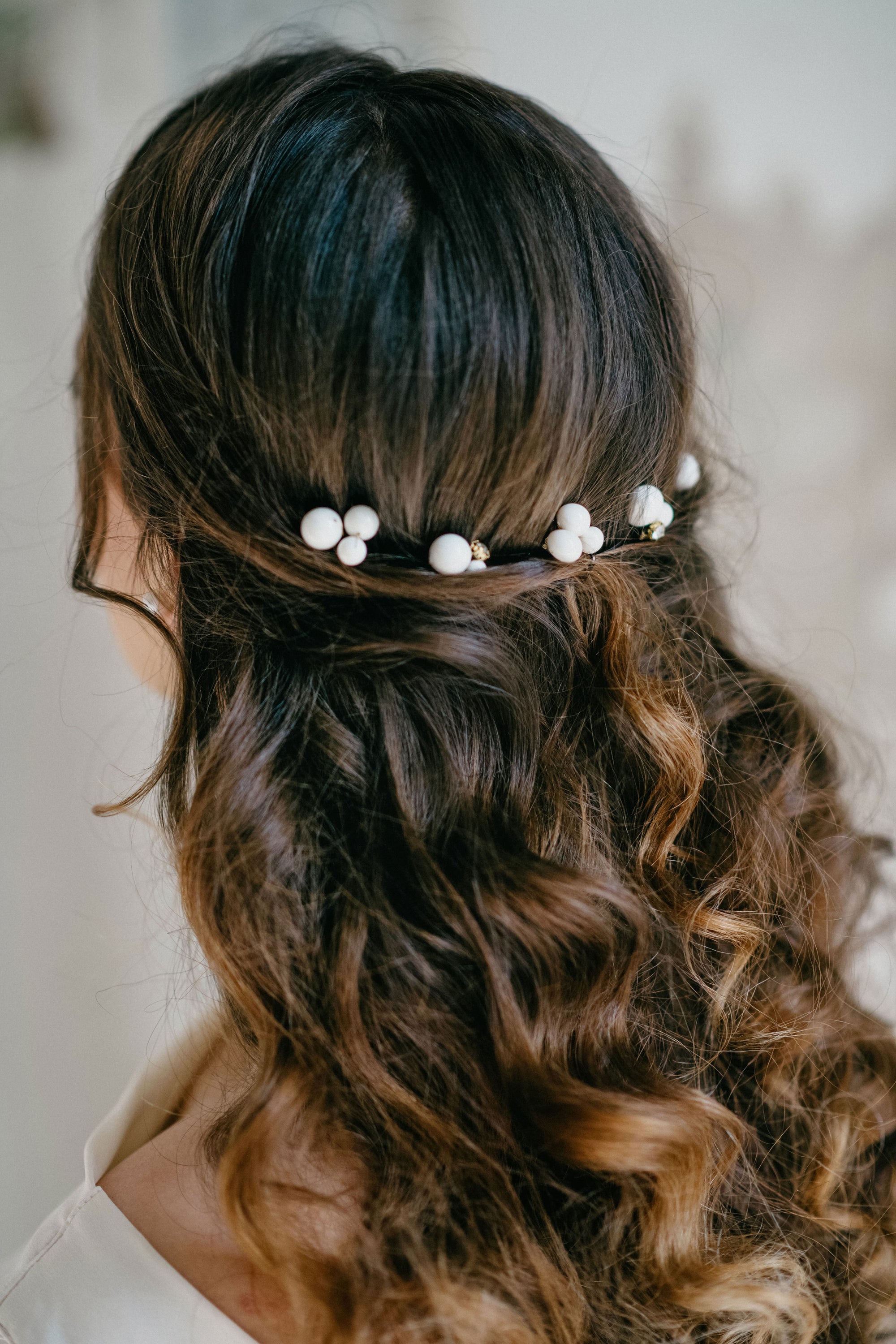 Minimalist pearl wedding hair pins with gold accents, side view