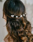 Minimalist pearl wedding hair pins with gold accents, side view