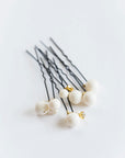 Set of ALSA large pearl hair pins on white background