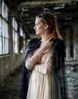 black wedding cloak on bride shoulders