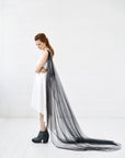 Bride wearing SABINE black floral cape veil draped across the back