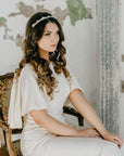 Modern pearl and crystal bridal headband worn by bride.