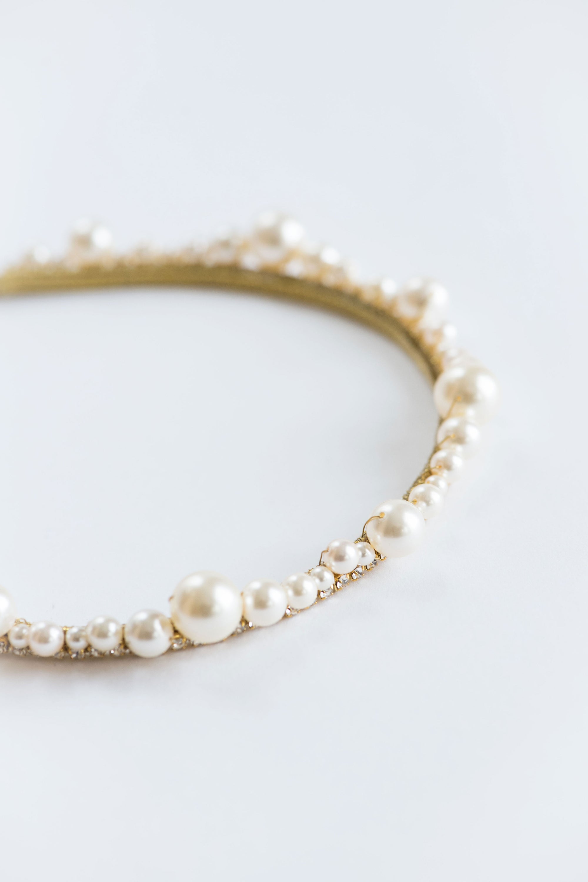 Pearl bridal headpiece side view showing slim lightweight structure and balanced scalloped design