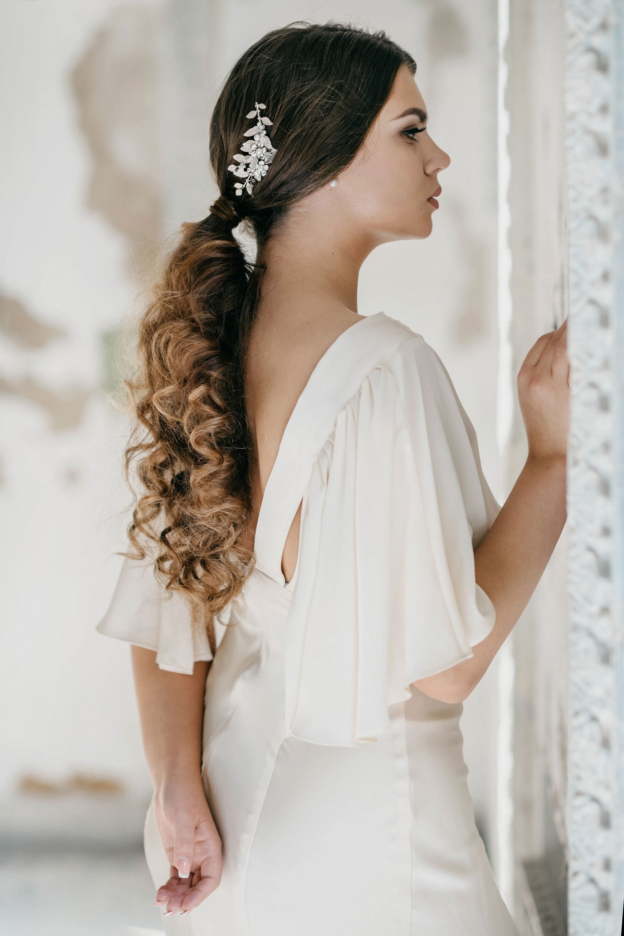 Model wearing TILLE silver leaf bridal hair comb with pearls and crystals
