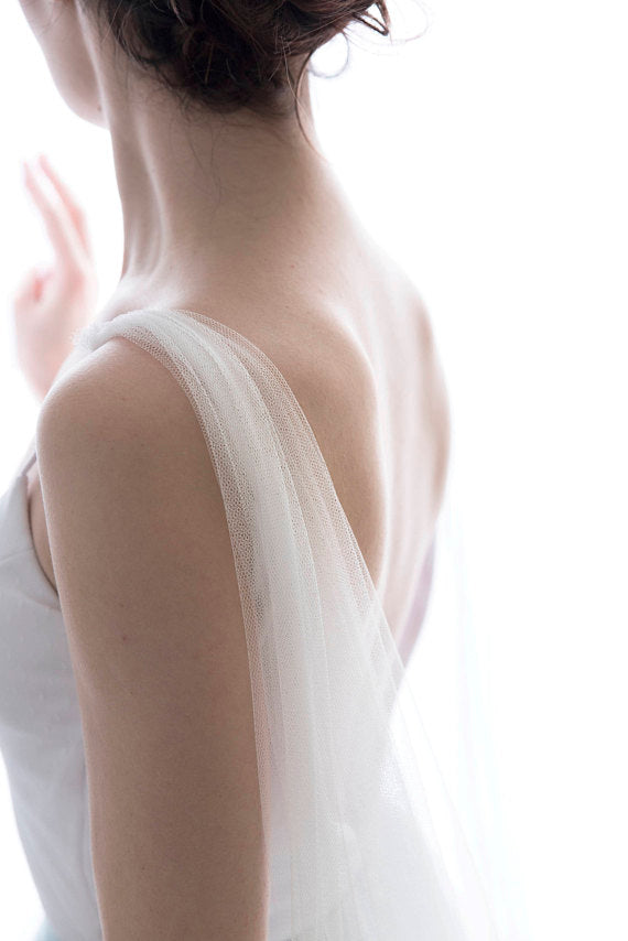 Soft English tulle bridal cape veil draped over shoulders, minimalist veil alternative for modern bride
