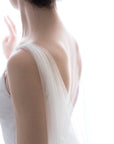 Soft English tulle bridal cape veil draped over shoulders, minimalist veil alternative for modern bride
