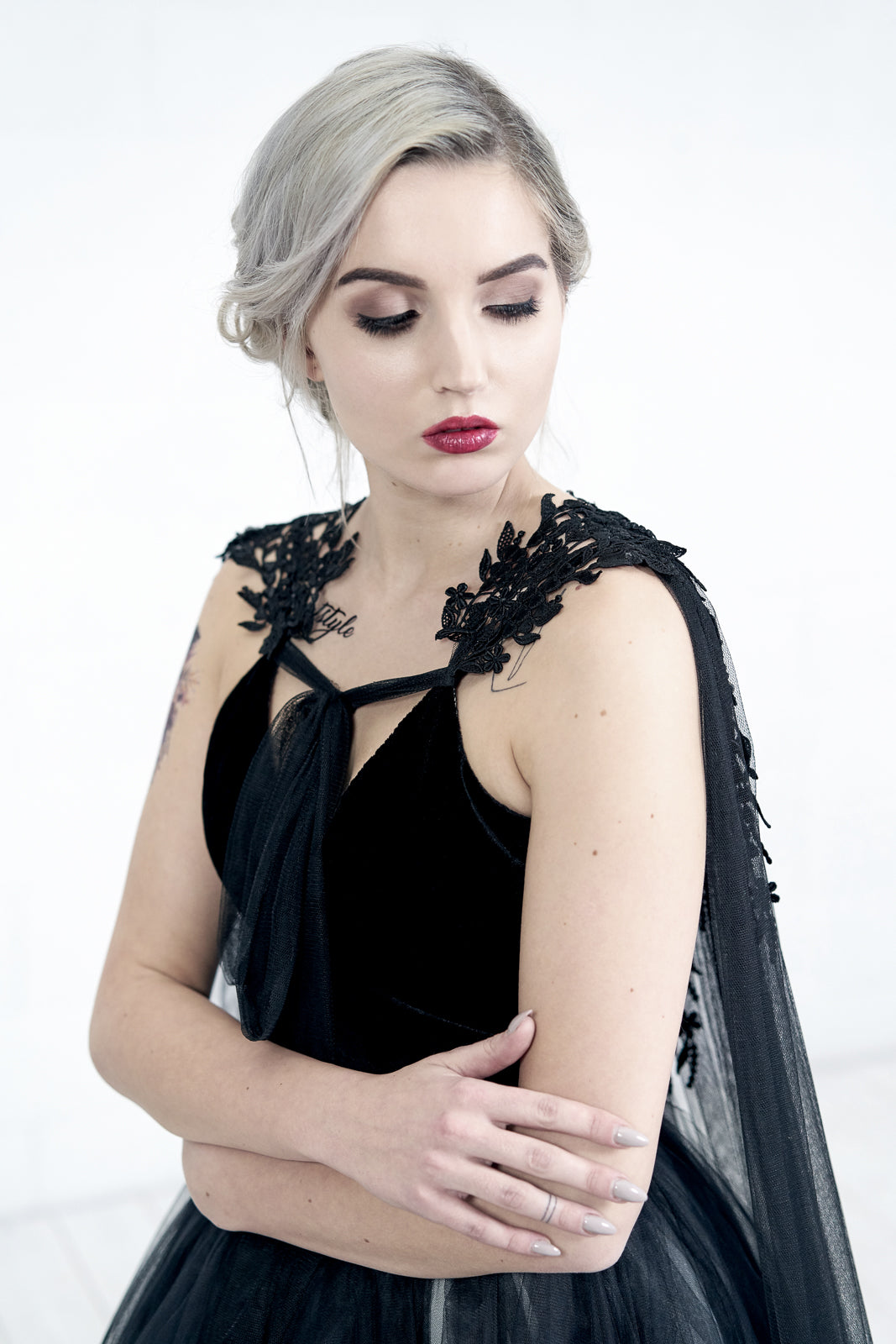 Front close-up of TARJA black bridal cape with lace and crystal embellishment